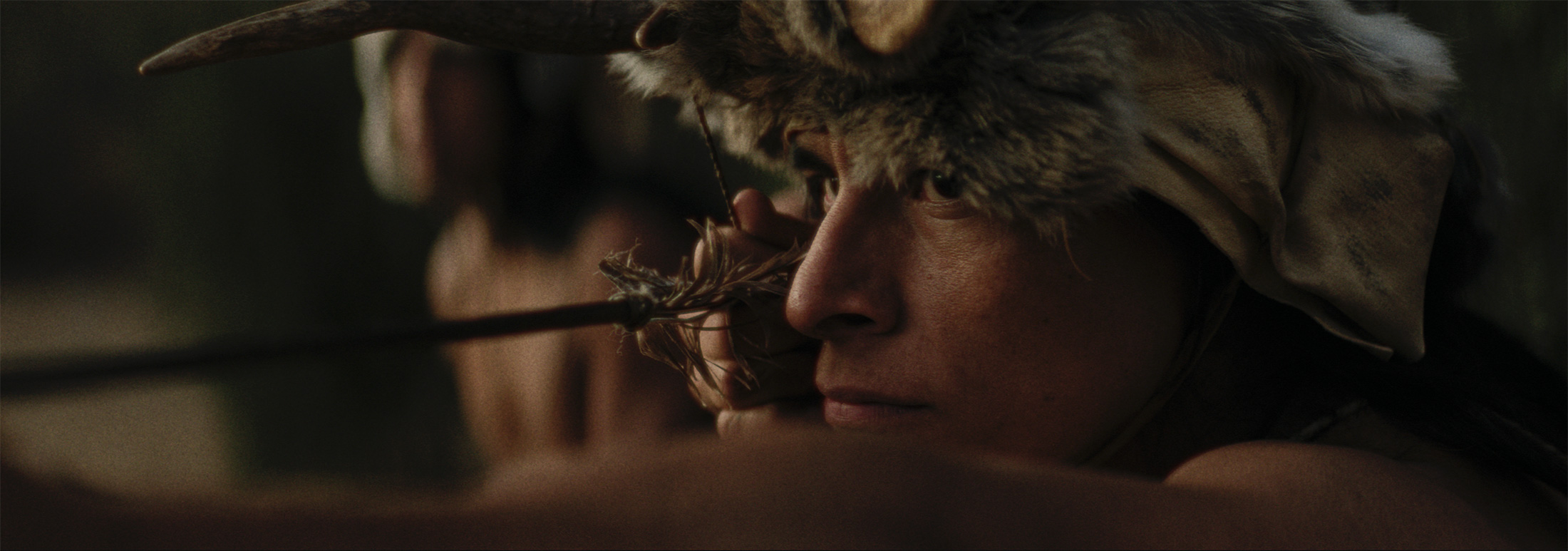 Native warrior close up showing ready to release his arrow from bow